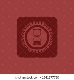 sand clock icon inside red emblem