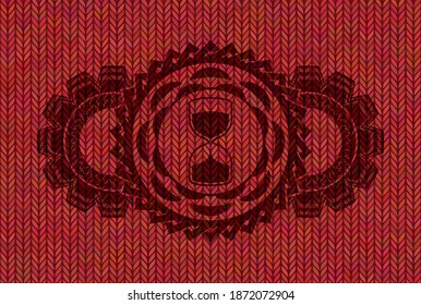 sand clock icon inside Red woolen fabric badge. Cloth handsome background. Illustration. 
