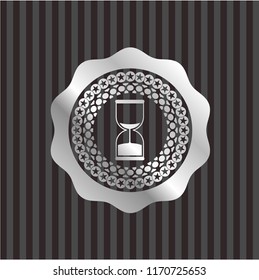 sand clock icon inside silver shiny emblem