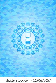 sand clock icon inside sky blue emblem with mosaic background