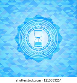 sand clock icon inside sky blue mosaic emblem