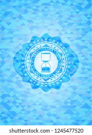 sand clock icon inside sky blue emblem. Mosaic background