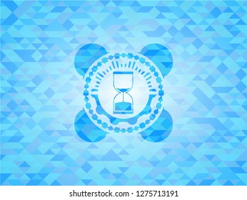 sand clock icon inside sky blue mosaic emblem