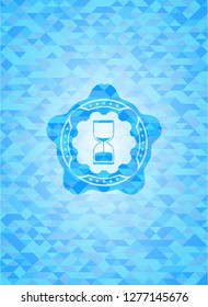 sand clock icon inside sky blue emblem with mosaic background