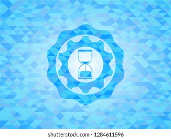 sand clock icon inside sky blue emblem with mosaic background