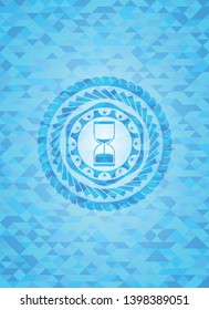 sand clock icon inside sky blue emblem. Mosaic background