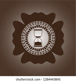 sand clock icon inside vintage wooden emblem