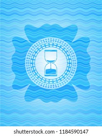 sand clock icon inside water badge background.