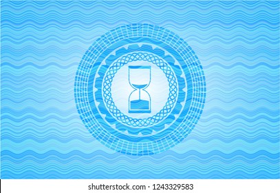 sand clock icon inside water wave badge.
