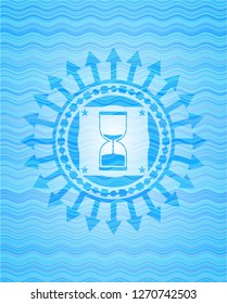 sand clock icon inside water concept badge background.