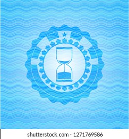 sand clock icon inside water wave concept style badge.