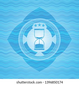 sand clock icon inside water wave emblem background.