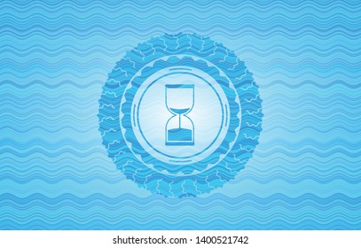 sand clock icon inside water wave representation badge.