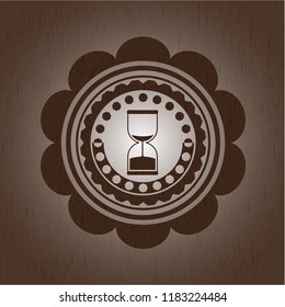 sand clock icon inside wood emblem