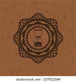 sand clock icon inside wood badge or emblem