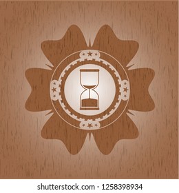 sand clock icon inside wooden emblem