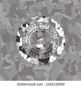 sand clock icon on grey camouflage pattern