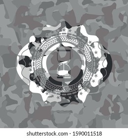sand clock icon on grey camouflage pattern