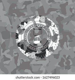 sand clock icon on grey camouflaged texture