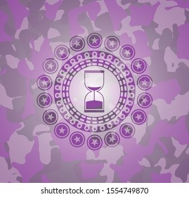 sand clock icon on pink and purple camouflage texture