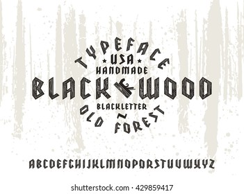 Sanserif font in black letter style decorated wood texture. Gothic typeface on forest texture background