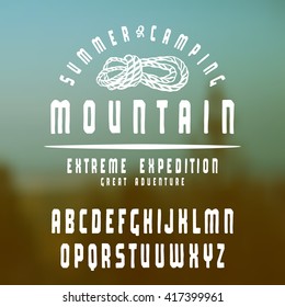 Sanserif font with hand-drawn soft shape. Graphic design for t-shirt. White print on blurred background