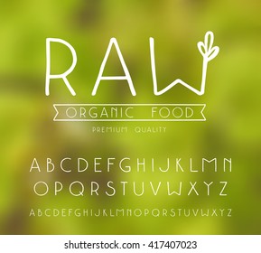 Sanserif font with hand-drawn soft shape. Raw vegan label. White print on blurred background