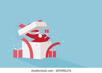 Santa Claus breaking out from a gift box. Festive background with copy space