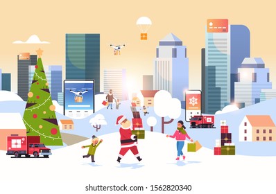 santa claus carrying gift boxes people with shopping bags walking outdoor preparing for christmas new year holidays men women using online mobile application winter cityscape background horizontal
