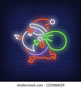 Santa Claus carrying sack neon sign. Christmas design. Night bright neon sign, colorful billboard, light banner. Vector illustration in neon style.