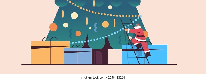 santa claus climbing gift box under fir tree happy new year merry christmas holiday celebration concept