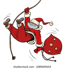 Santa Claus descends on a rope with gifts. Christmas and New Year winter holidays