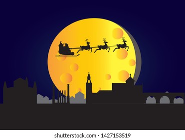Santa Claus flying over city skyline of Cordoba in Spain