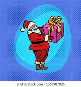 Santa Claus with gift box. Christmas and New year Comic cartoon pop art retro vector drawing illustration