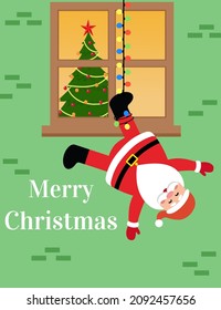 Santa Claus is hanging upside down on a garland and smile on a house window background. Merry Christmas greeting card for present.