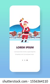 santa claus holding bell merry christmas happy new year holiday concept smartphone screen online mobile app winter houses snowy town street greeting card full length vertical vector illustration