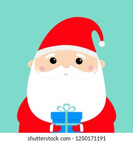 Santa Claus holding gift box. Funny face head. Candy cane. Merry Christmas. New Year. Red hat. Moustaches, beard. Cute cartoon funny kawaii baby character. Flat design. Blue background. Vector