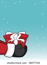 Santa Claus holding a present on a sky background with snow