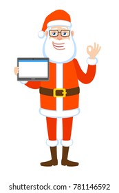 Santa Claus holding tablet PC and showing a okay hand sign. Full length portrait of Cartoon Santa Claus Character. Vector illustration in a flat style.