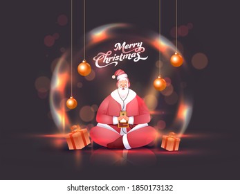 Santa Claus listen to music from headphones by smartphone with gift boxes, hanging shiny baubles on the occasion of Merry Christmas.