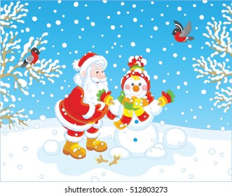 Santa Claus making a funny smiling snowman with a cap, a scarf and mittens