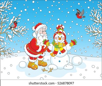 Santa Claus making a funny smiling snowman with a cap, a scarf and mittens