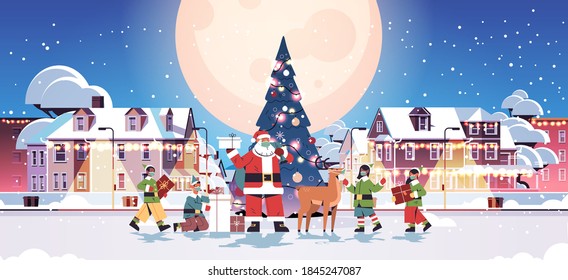 santa claus with mix race elves in masks preparing gifts happy new year merry christmas holidays celebration concept cityscape background full length horizontal vector illustration