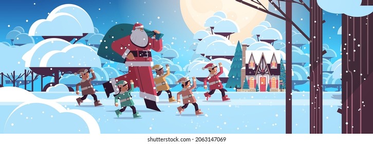 santa claus with mix race elves in night snowy forest happy new year merry christmas holidays celebration concept