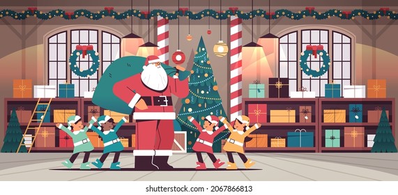 Santa Claus With Mix Race Elves Preparing For New Year And Christmas Holidays Celebration Modern Workshop Interior