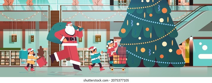 santa claus with mix race elves preparing for new year and christmas holidays celebration