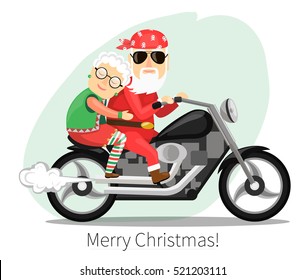 Santa Claus and Mrs Claus  riding on a steep motorcycle