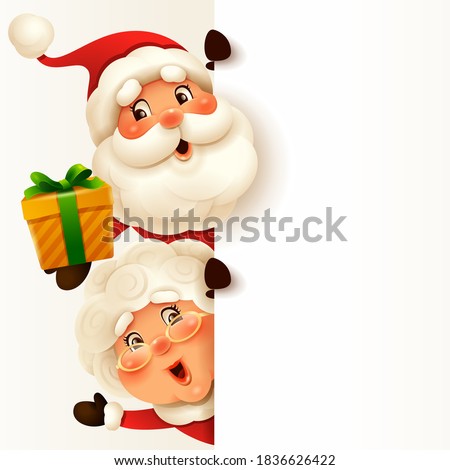 Santa Claus and Mrs.Claus with big blank signboard. Wide empty space for design.