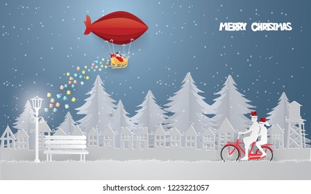 Santa Claus on Red balloon in the sky coming to city Landscape,Merry Christmas concept .Paper craft style vector and illustration