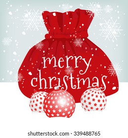 Santa Claus red bag with Merry Christmas text message and glass ornaments on snow